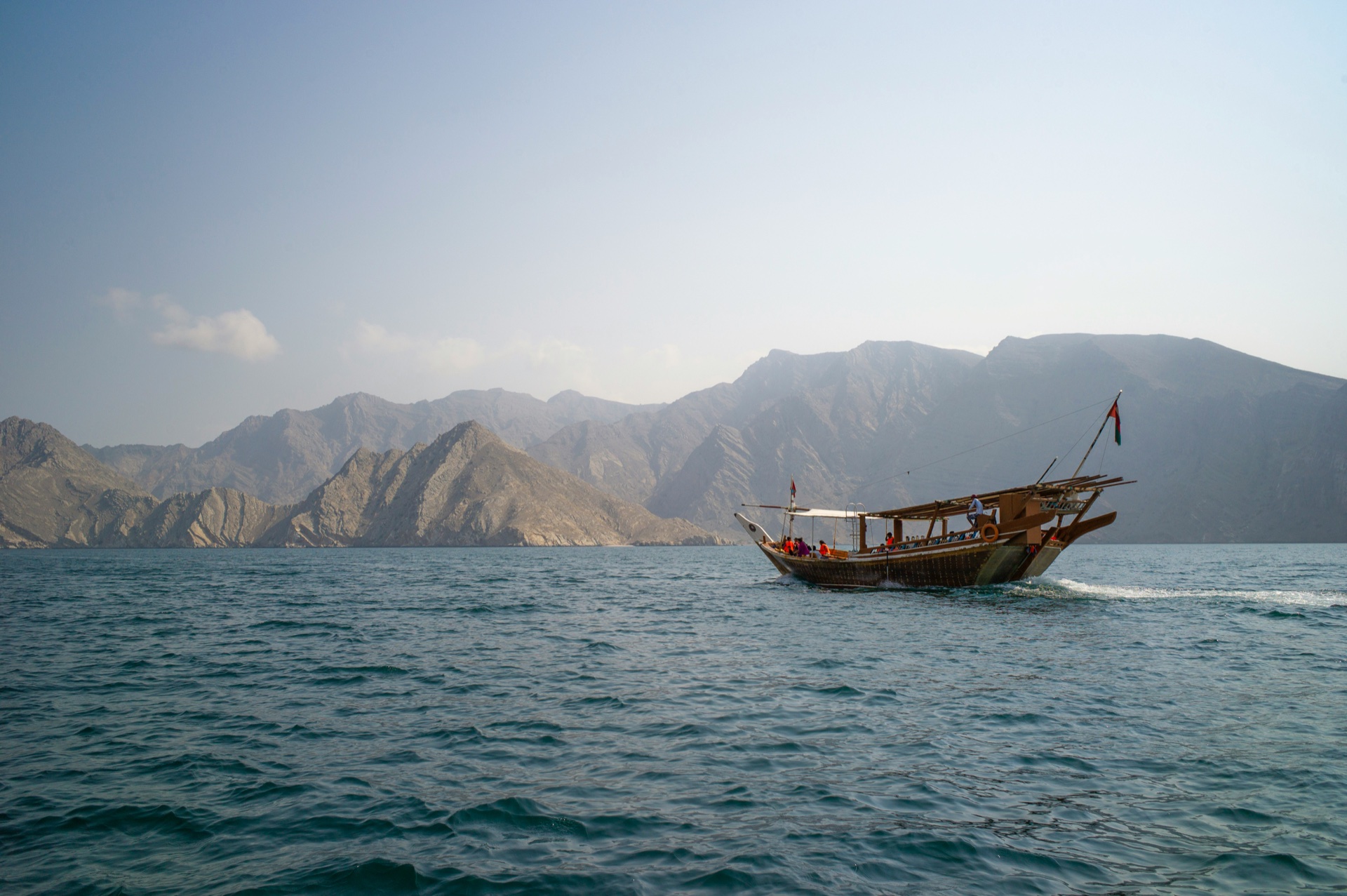 Traditional dhow sailing through Musandam fjords